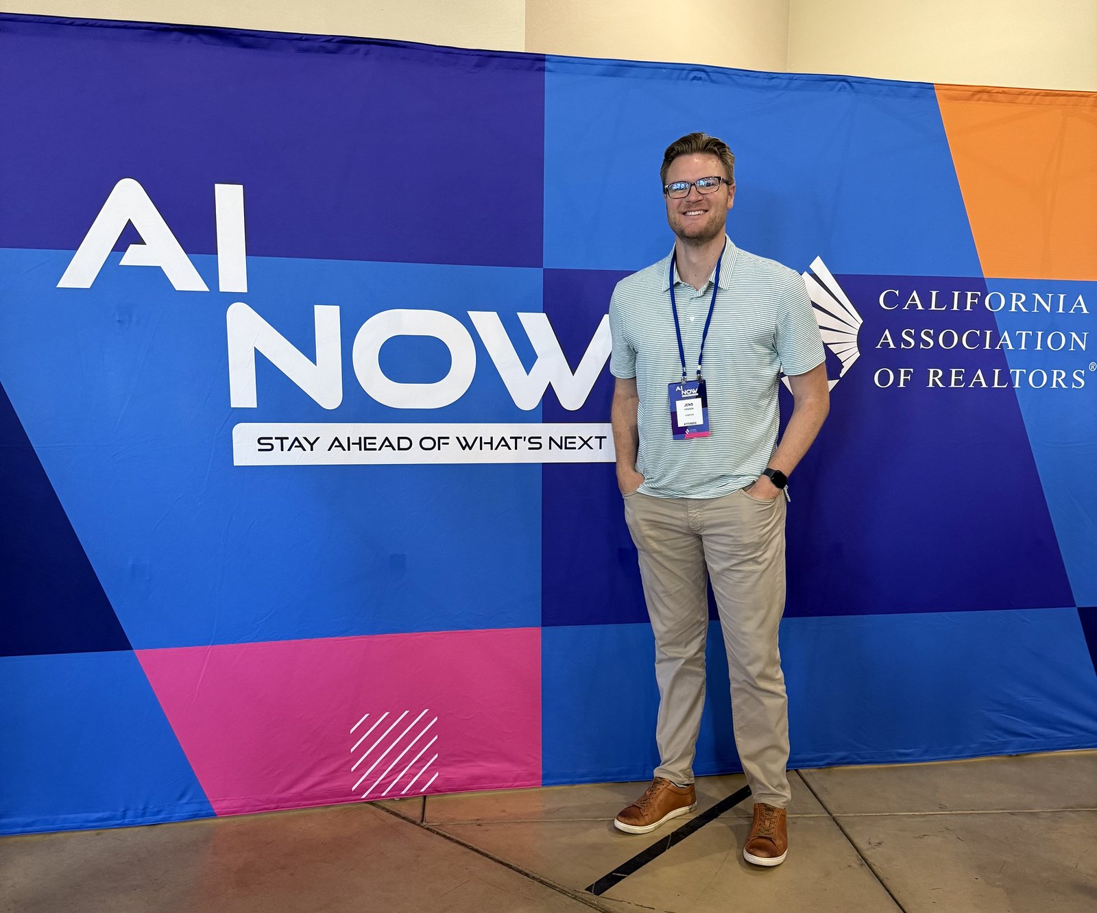 Jens Hansen at the California Association of REALTORS AI NOW conference, standing in front of the 'AI NOW — Stay Ahead of What's Next' backdrop.